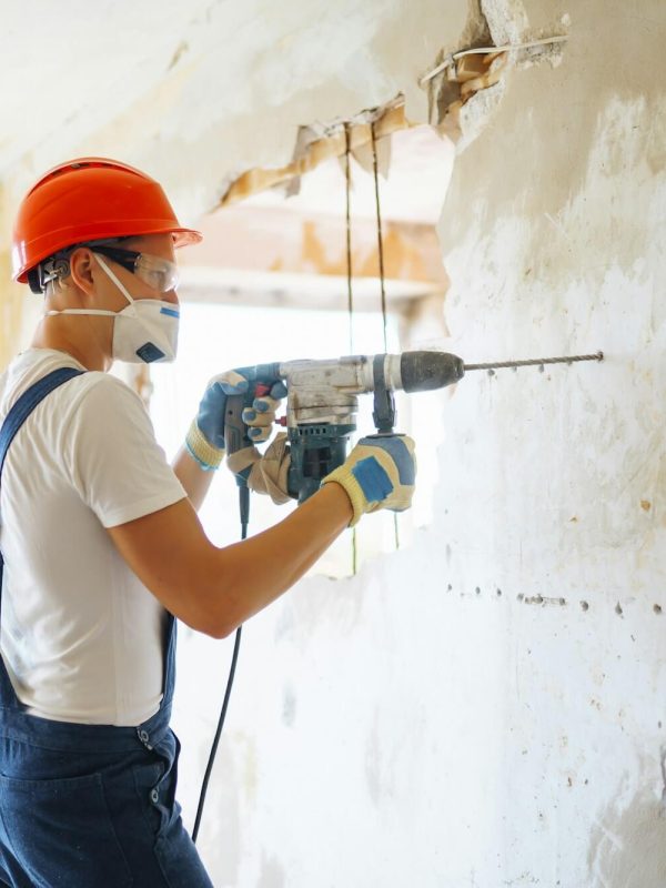 repairer in boilersuit holding tools apartment repair and renovation concept building